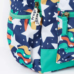 A close up of the Frugi magic stars explorer backpack showing the bottle holder, compartment zips and the playful outer space inspired print detail