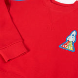 Close up of the rocket applique on the front of the Frugi Falmouth scarlet red sweatshirt.