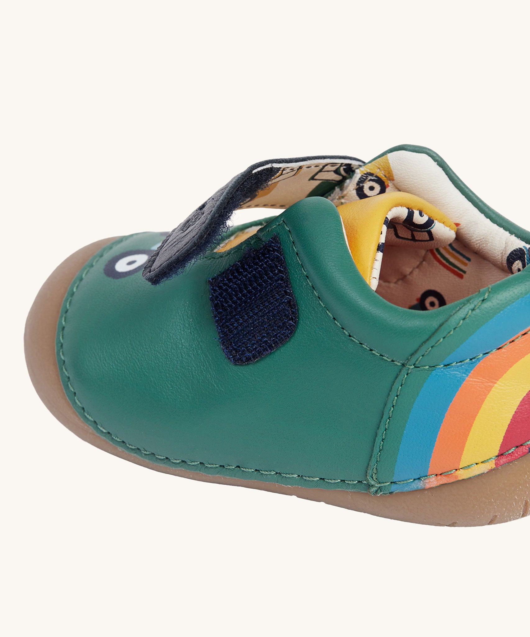 A close up of the velcro fastening on the side of the Fjord First Walker leather baby shoes in a holly green colour.