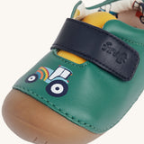 A close up of the tractor design on the front of the Fjord First Walker leather holly green baby shoes.