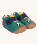 The Fjord First Walker leather baby shoes in a holly green colour have a tractor design on the front and a rainbow design on the back. The leather lining has a cream background with a colourful tractor print inside.