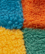A close up of the Frugi kids fleece bucket hat in hotchpotch showing the thick fleece detai on 100% recycled polyester fabric.
