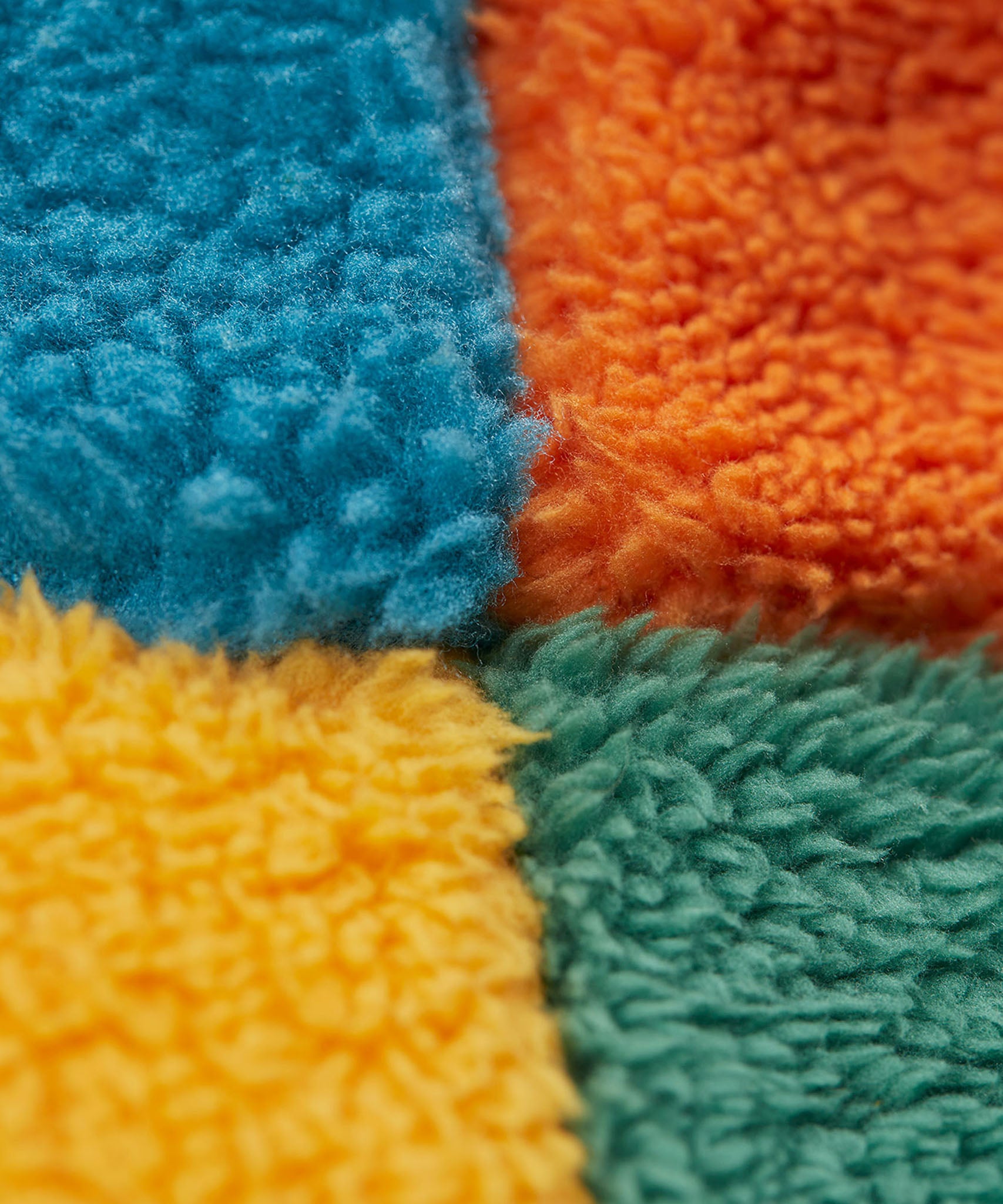 A close up of the Frugi kids fleece bucket hat in hotchpotch showing the thick fleece detai on 100% recycled polyester fabric.