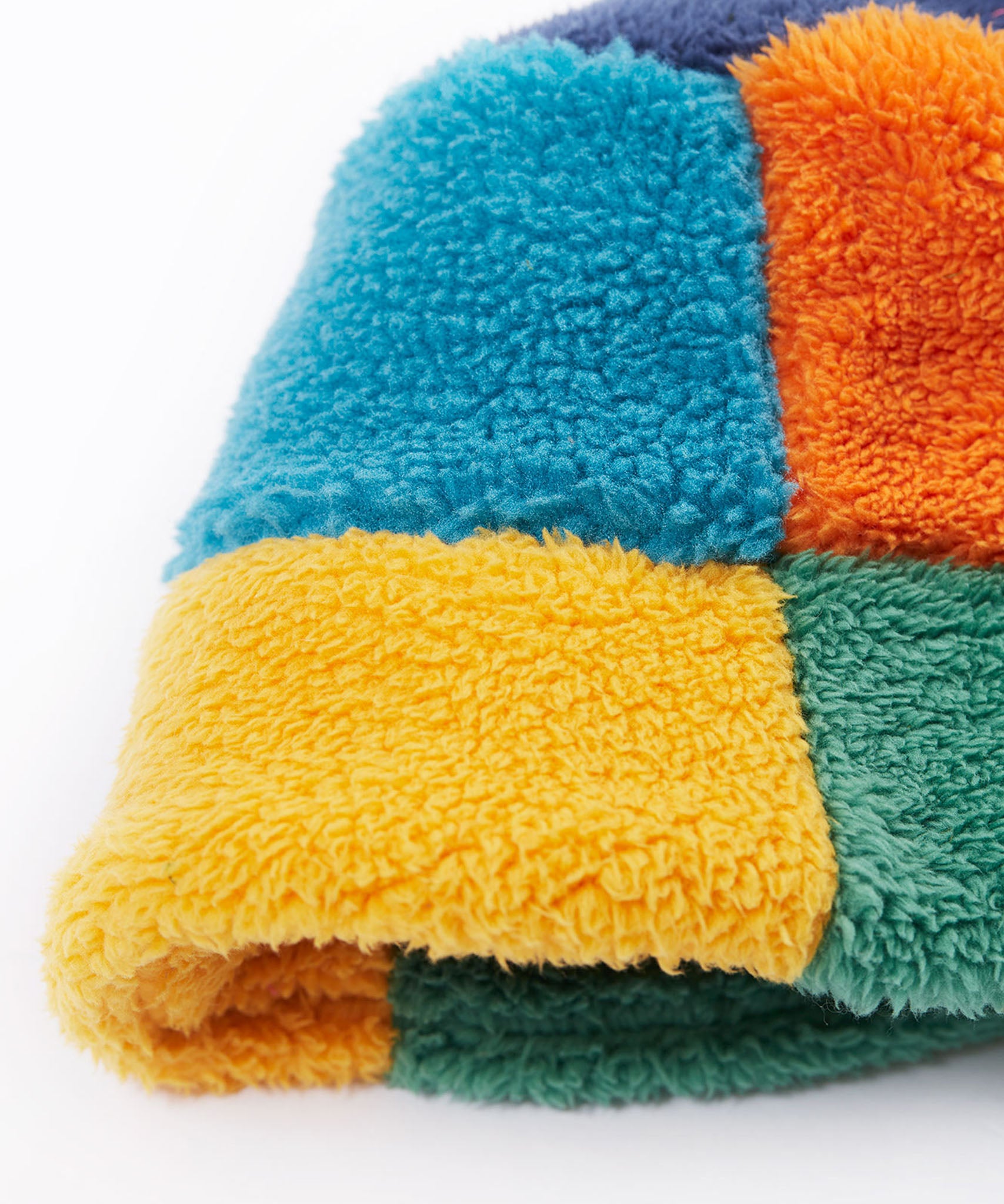 A close up of the Frugi kids fleece bucket hat in hotchpotch showing the multicoloured block detail on 100% recycled polyester fabric.
