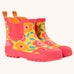 Frugi rain or shine short welly boots with a floral fields design. A yellow background  with orange and pink  flower print  and pink soles and binding.