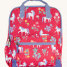 Frugi explorers backpack in rose horse floral. A pink backpack with lilac trim and a white unicorn print. Features a main compartment a smaller compartment on the front and a bottle holder