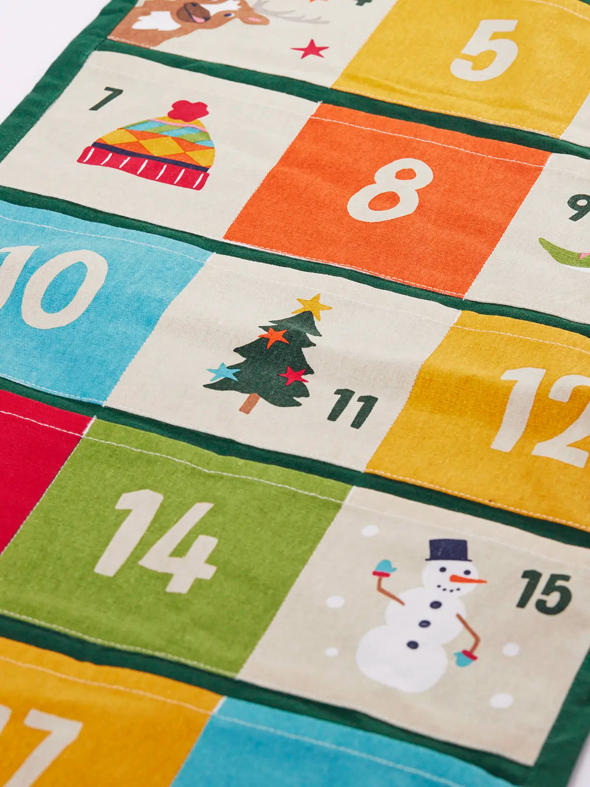 Colourful Frugi forest festive fun organic cotton advent calendar. 24 pockets with alternating colourful illustrations and colour blocks. 