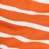 Close up of the wide orange stripe trousers from the Frugi frankie organic cotton baby and toddler outfit with Nessie design. 