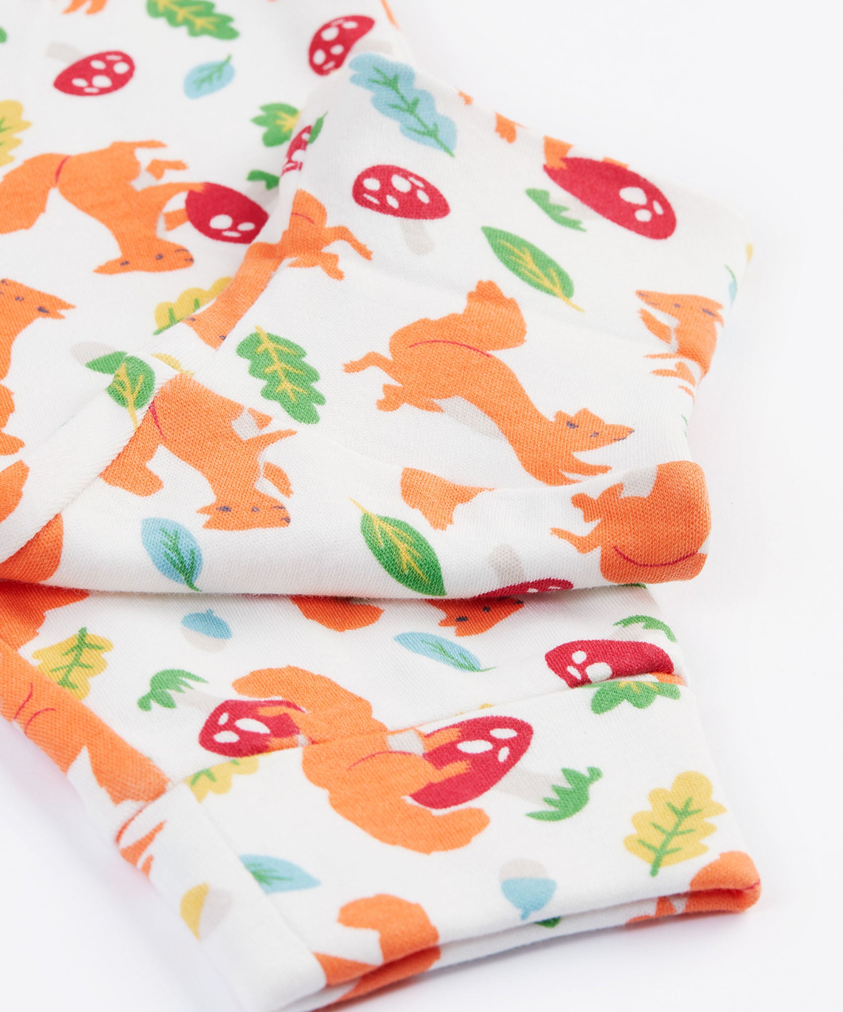 A close up of the patterned trousers from the Frugi Frankie Outfit with a bumblebee yellow stripe and squirrel friends design. 