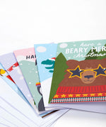 The five Frugi FSC Christmas Cards, on top is the bear design with the slogan "Have a beary merry Christmas"