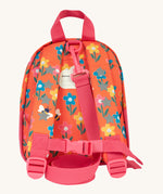 The back of the Frugi little adventures fun flowers backpack showing the reflective stars on the shoulder straps and the pink rein clipped to the top of the bag