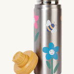 Frugi kids Insulated bottle in fun flowers. A stainless steel bottle with playful flower prints. Features a yellow cap with a loop that can be screwed on and off the bottle