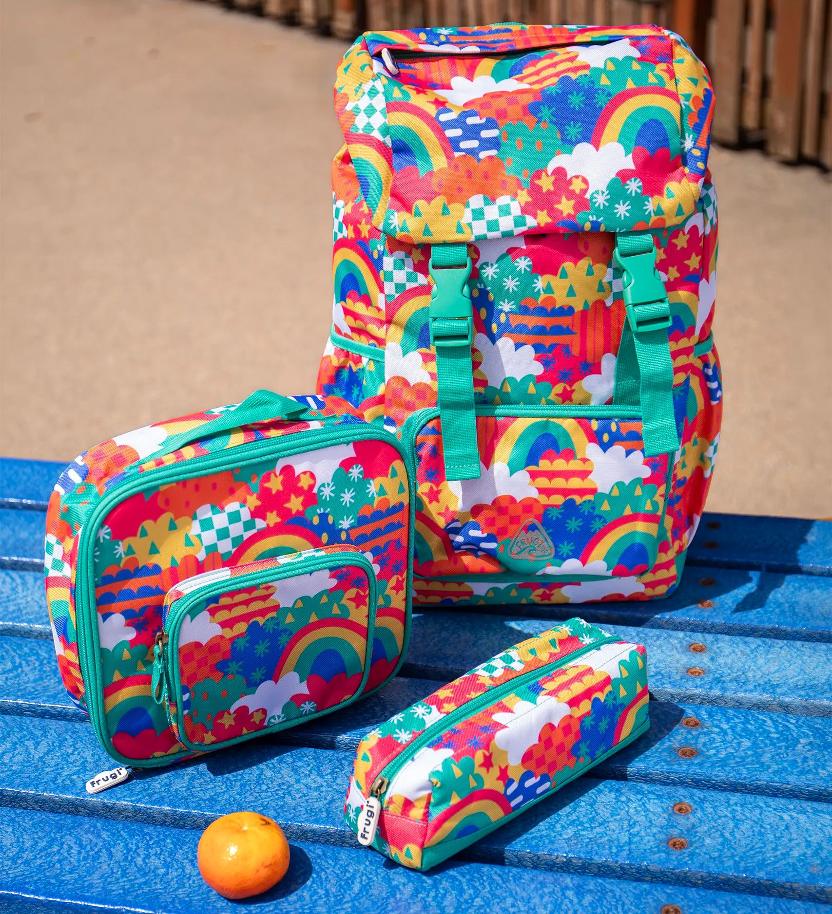 Frugi trail blazing kids backpack, matching lunch bag and pencil case in the colourful fun frenzy pattern.