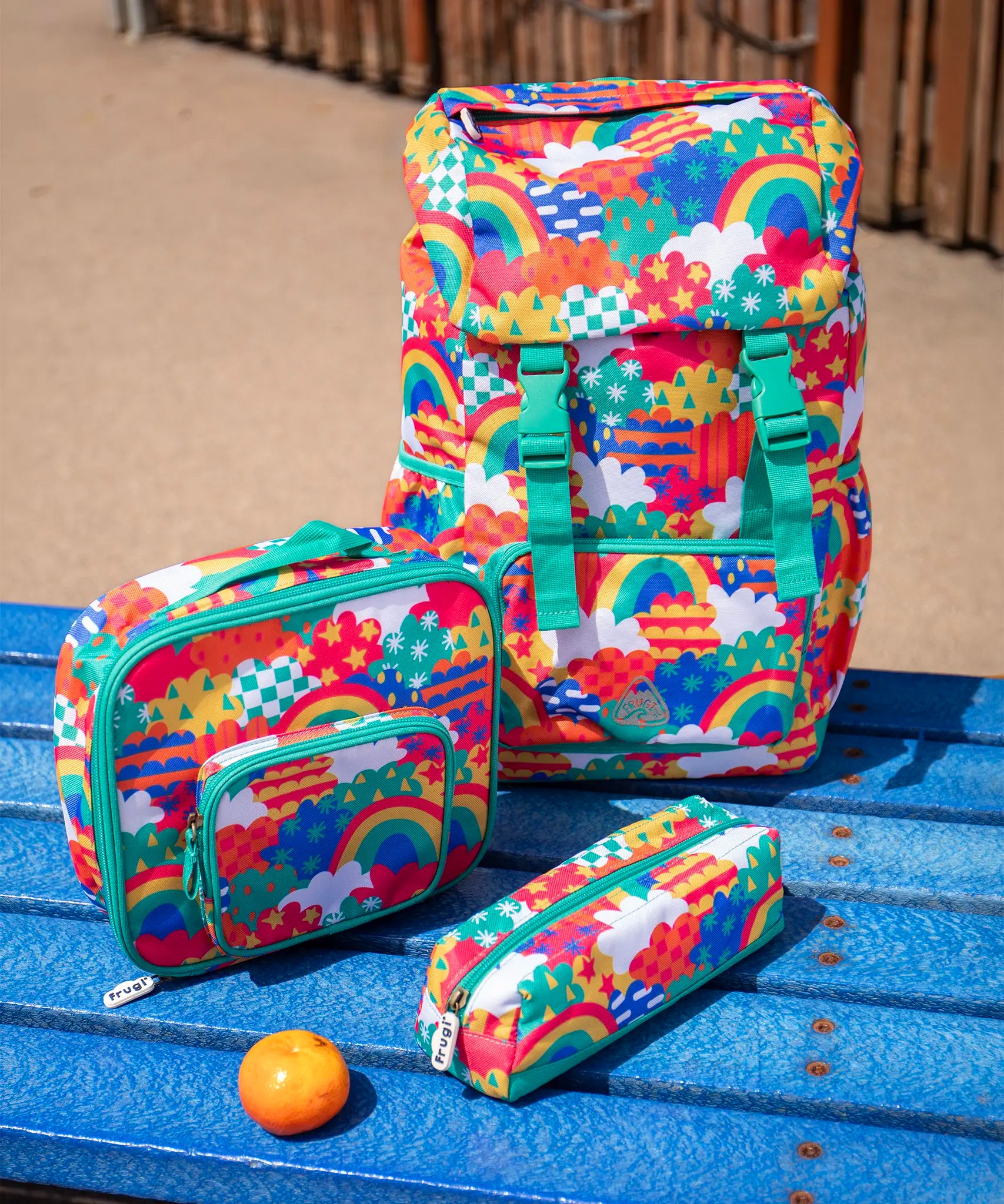 Frugi trail blazing kids backpack, matching lunch bag and pencil case in the colourful fun frenzy pattern.
