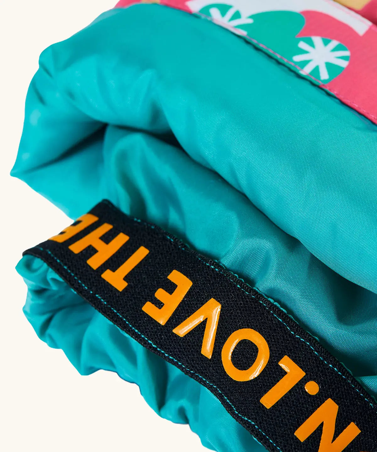 Frugi fun frenzy snow and ski salopettes showing close up of the orange elasticated cuff 