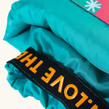 Frugi fun frenzy snow and ski salopettes showing close up of the orange elasticated cuff 