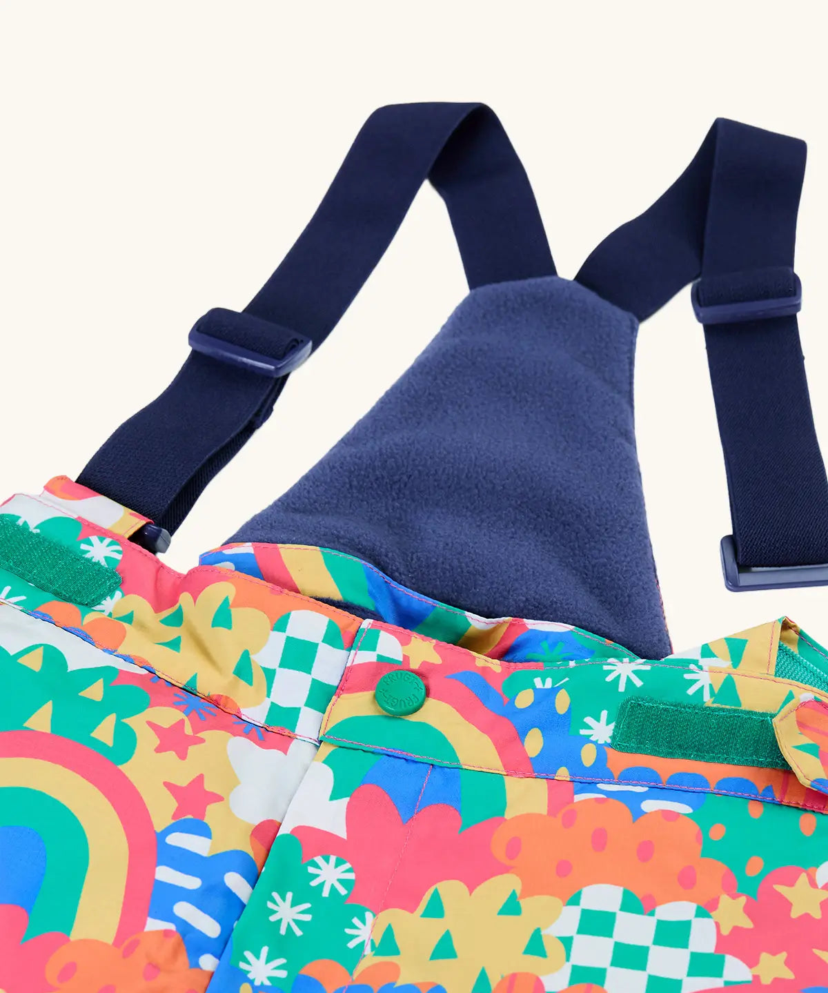 Frugi kids snow and ski salopettes in fun frenzy showing the removable navy shoulder strap and matching fleece back panel 