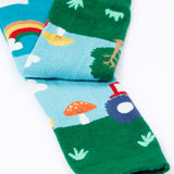 A close up of the bottom cuff on the Frugi organic cotton little knitted leggings with a fun guys red mushroom and farm design.