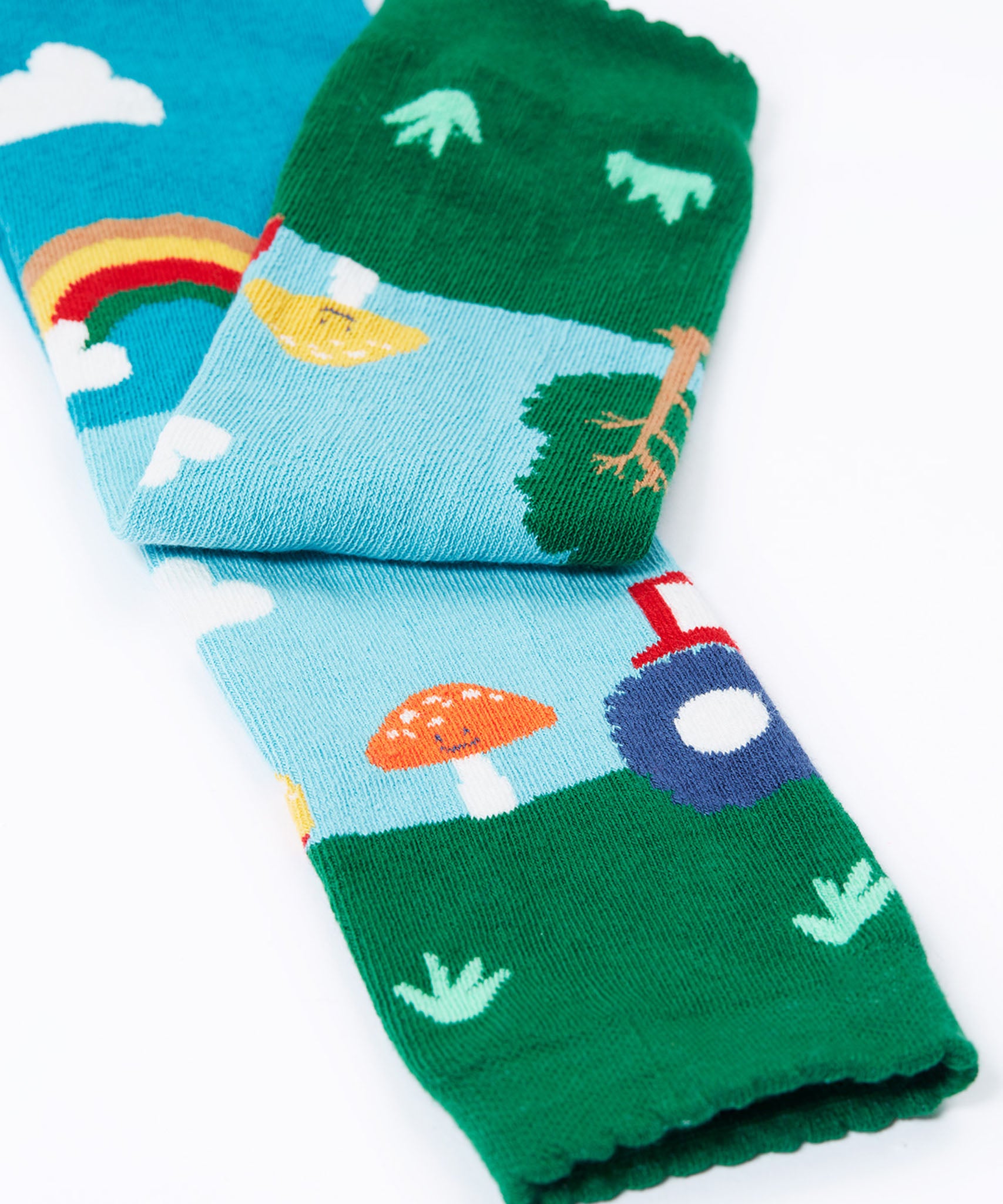 A close up of the bottom cuff on the Frugi organic cotton little knitted leggings with a fun guys red mushroom and farm design.