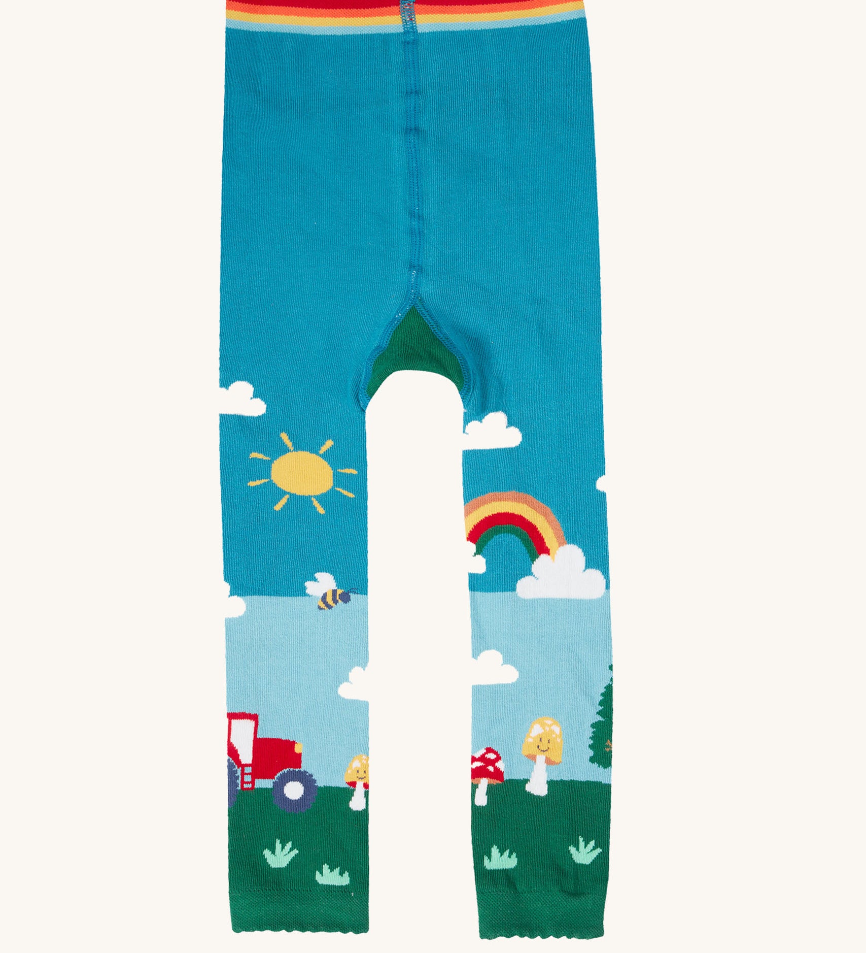 A view of the front of the Frugi organic cotton little knitted leggings with a fun guys red mushroom and farm design.