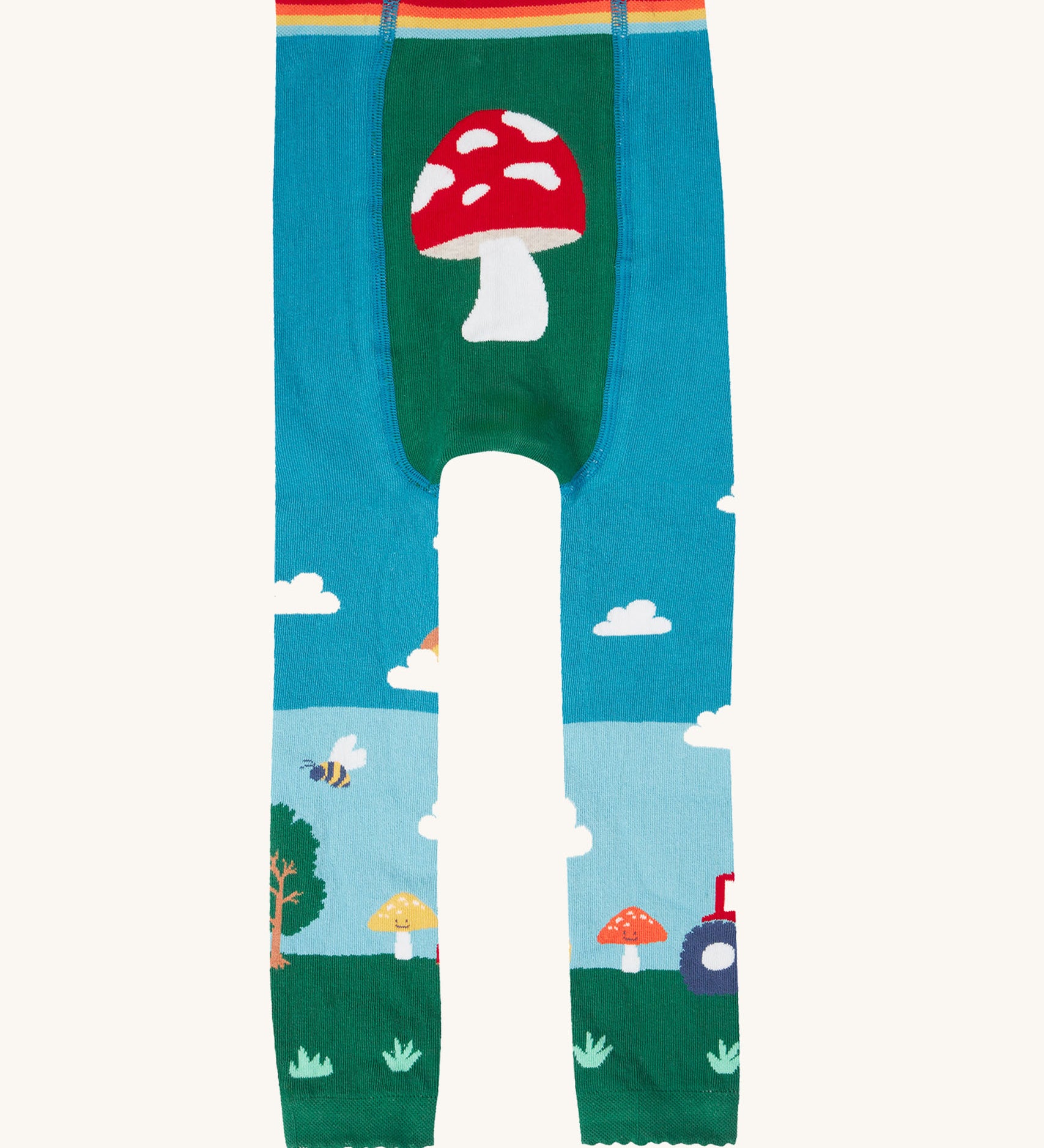 A view of the back of the Frugi organic cotton little knitted leggings with a fun guys red mushroom and farm design.