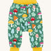 The Frugi fun guys multi coloured mushroom print parsnip pants children's trousers. The print features multi-coloured mushrooms, light green leaves on a dark green background with yellow cold coloured waistband and leg cuffs. 