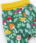 A close up of the mushroom themed print on the Frugi fun guys parsnip pants.