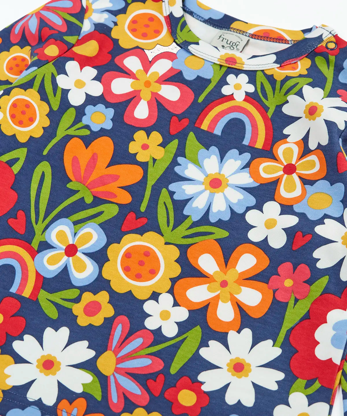 Close up of the colourful flower print on the Frugi goldie long sleeve organic cotton top in navy.