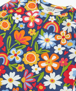 Close up of the colourful flower print on the Frugi goldie long sleeve organic cotton top in navy.