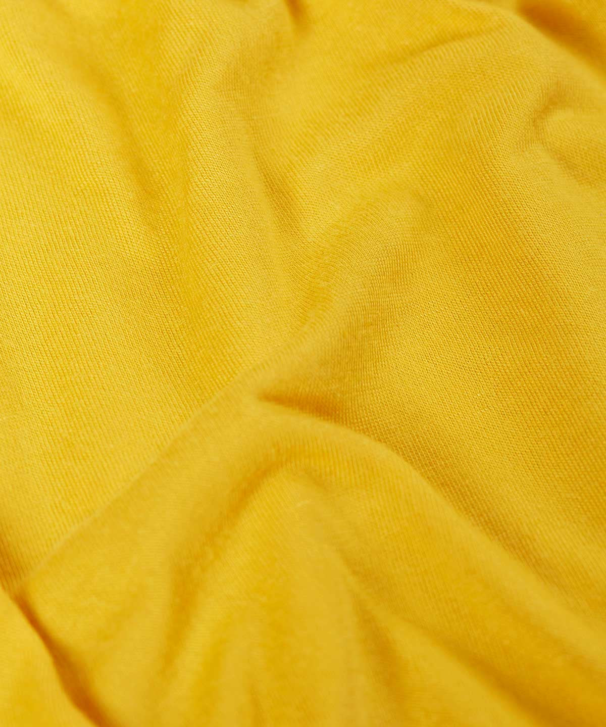 The bright yellow coloured lining inside the Frugi cobalt blue coloured rain jacket