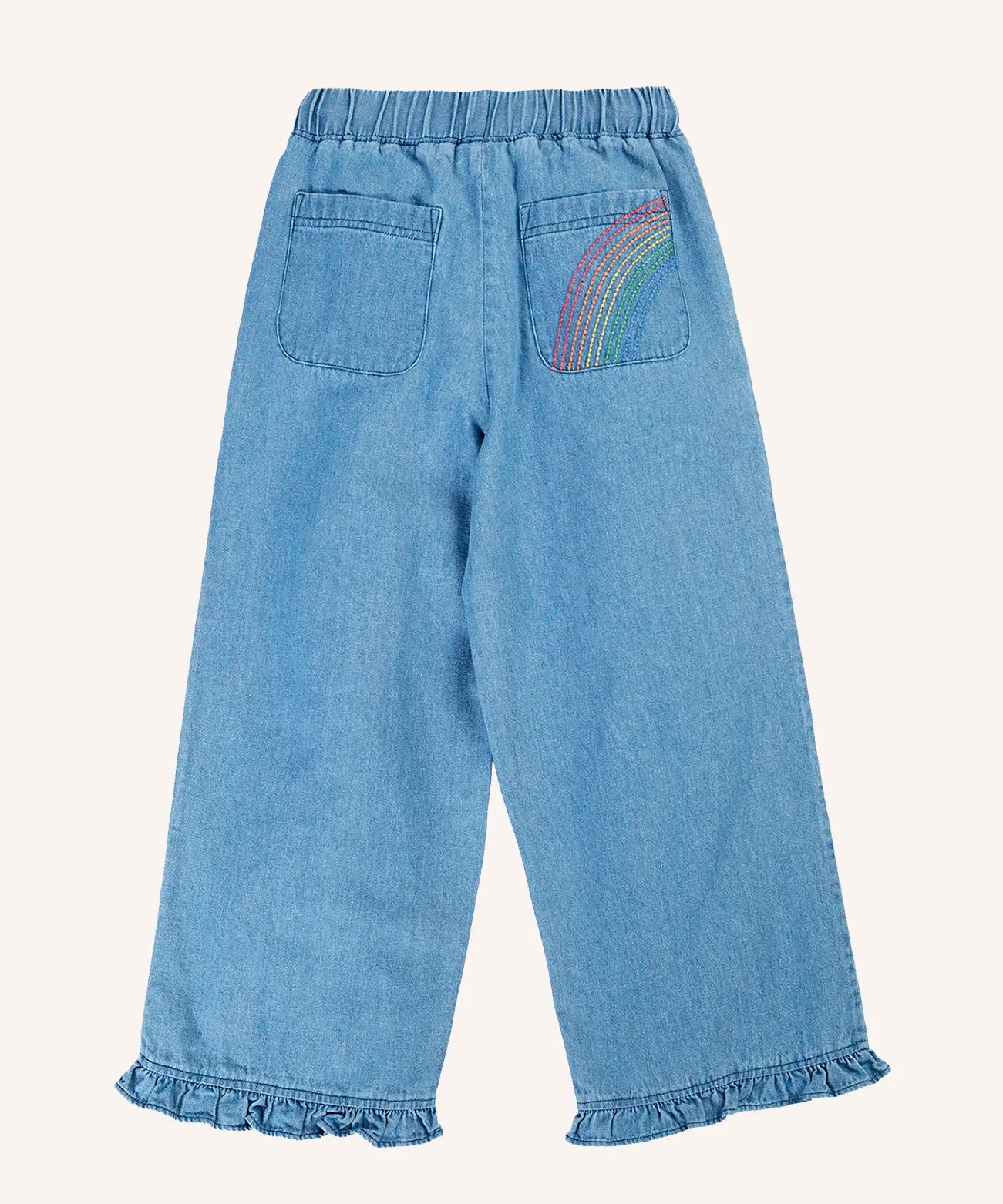 Back of Frugi grace denim trousers with rainbow embroidery design o none of the back pockets and ruffle hem cuffs on the legs,