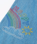 Frugi GOTS organic cotton denim trousers showing close up of a rainbow embroidery design on the leg