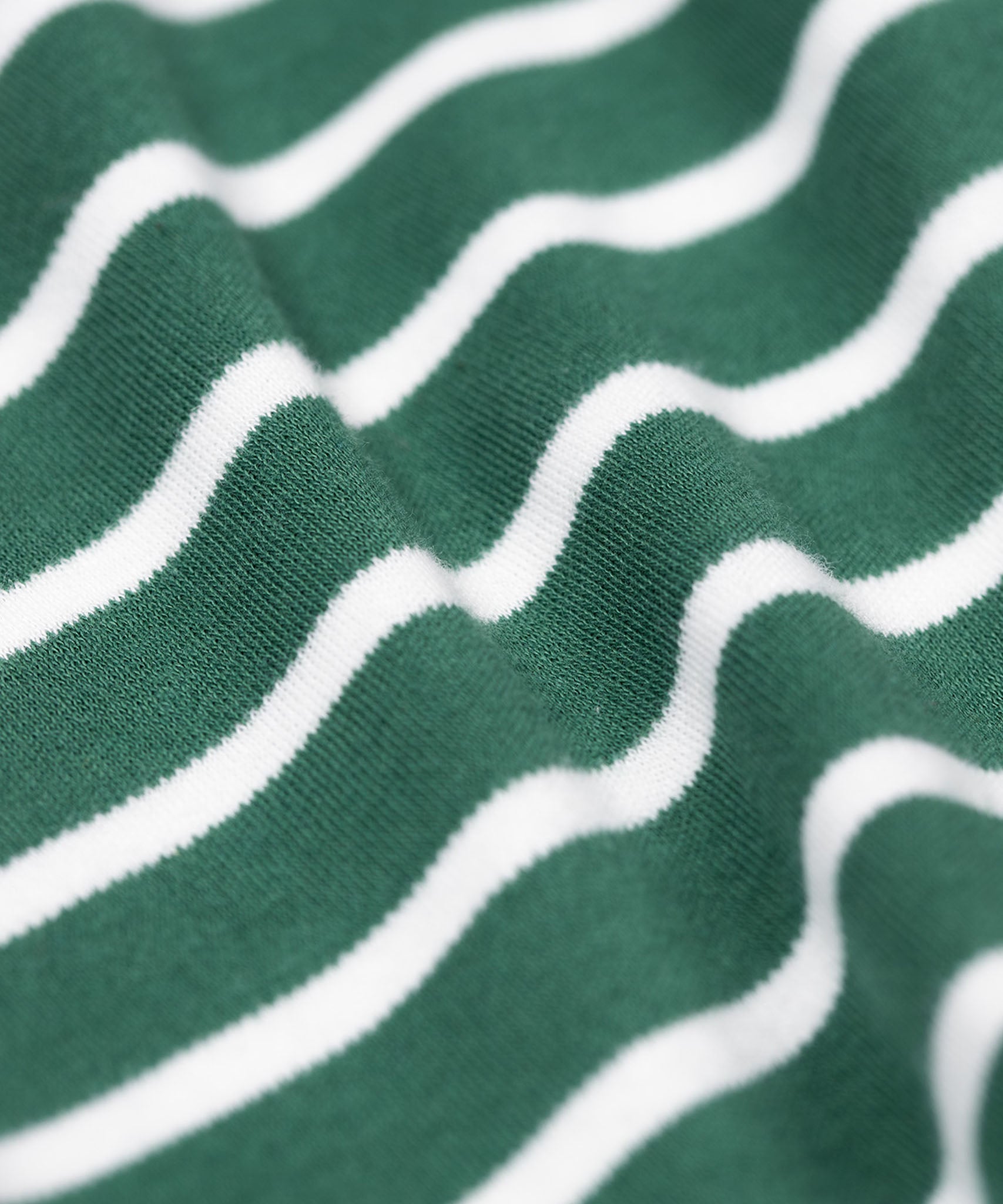 A close up of the soft organic cotton of the Frugi easy on long sleeved top holly green breton stripe with fox applique.