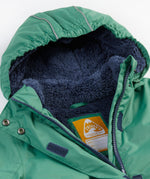 A close up of the Frugi kids snow and ski coat in green with a mountain scene print. Showing the thick navy fleece inner on the hood and zip detail 
