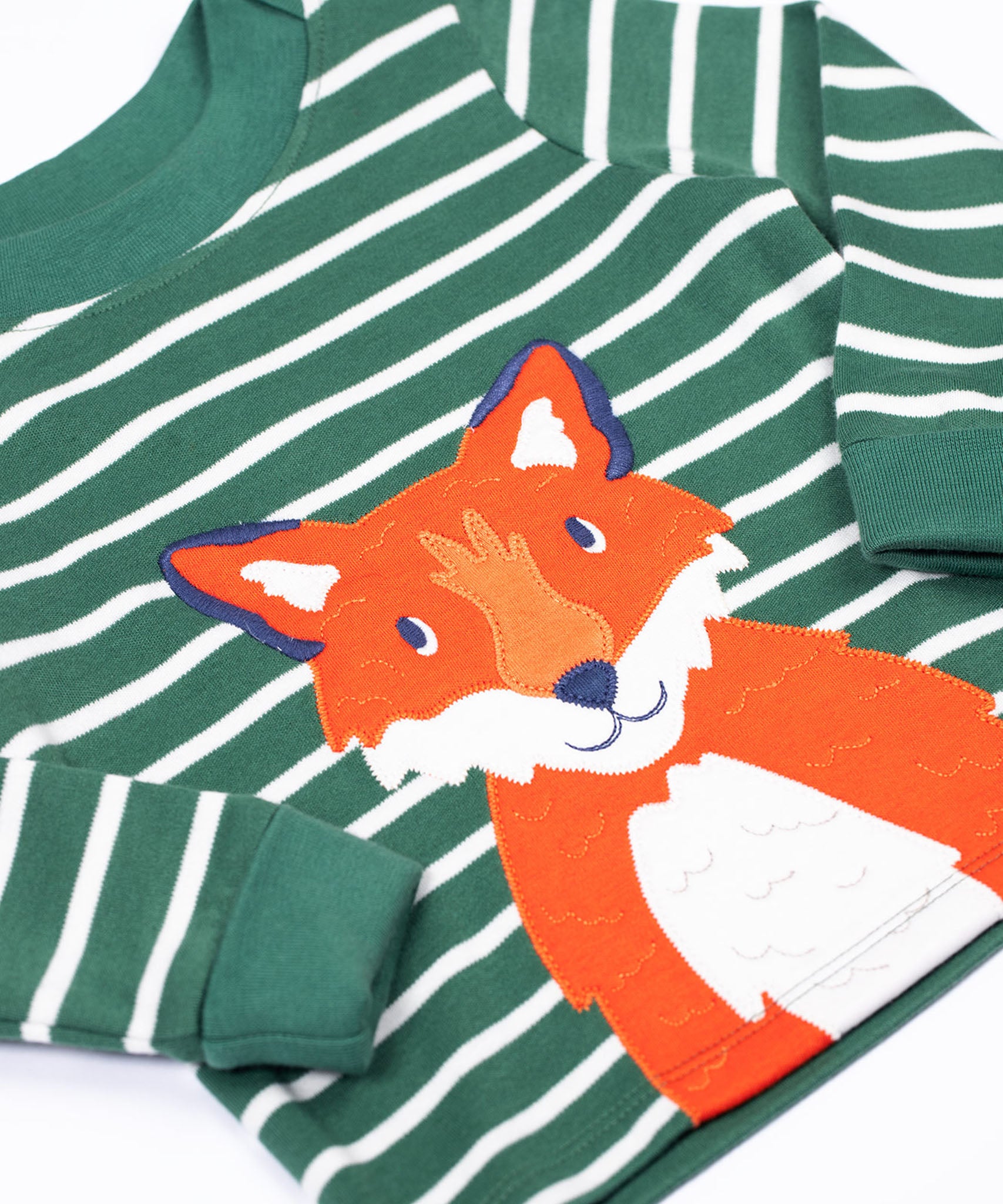 A close up of the front of the Frugi easy on long sleeved top holly green breton stripe with fox applique.