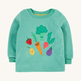 Frugi kids green fleece jumper with veg design on a cream backgroud.