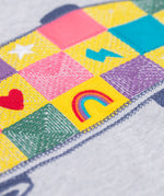 A close up of the embroidered skatebaord design on the front of the Frugi Superb Stitched Skateboard sweatshirt. 
