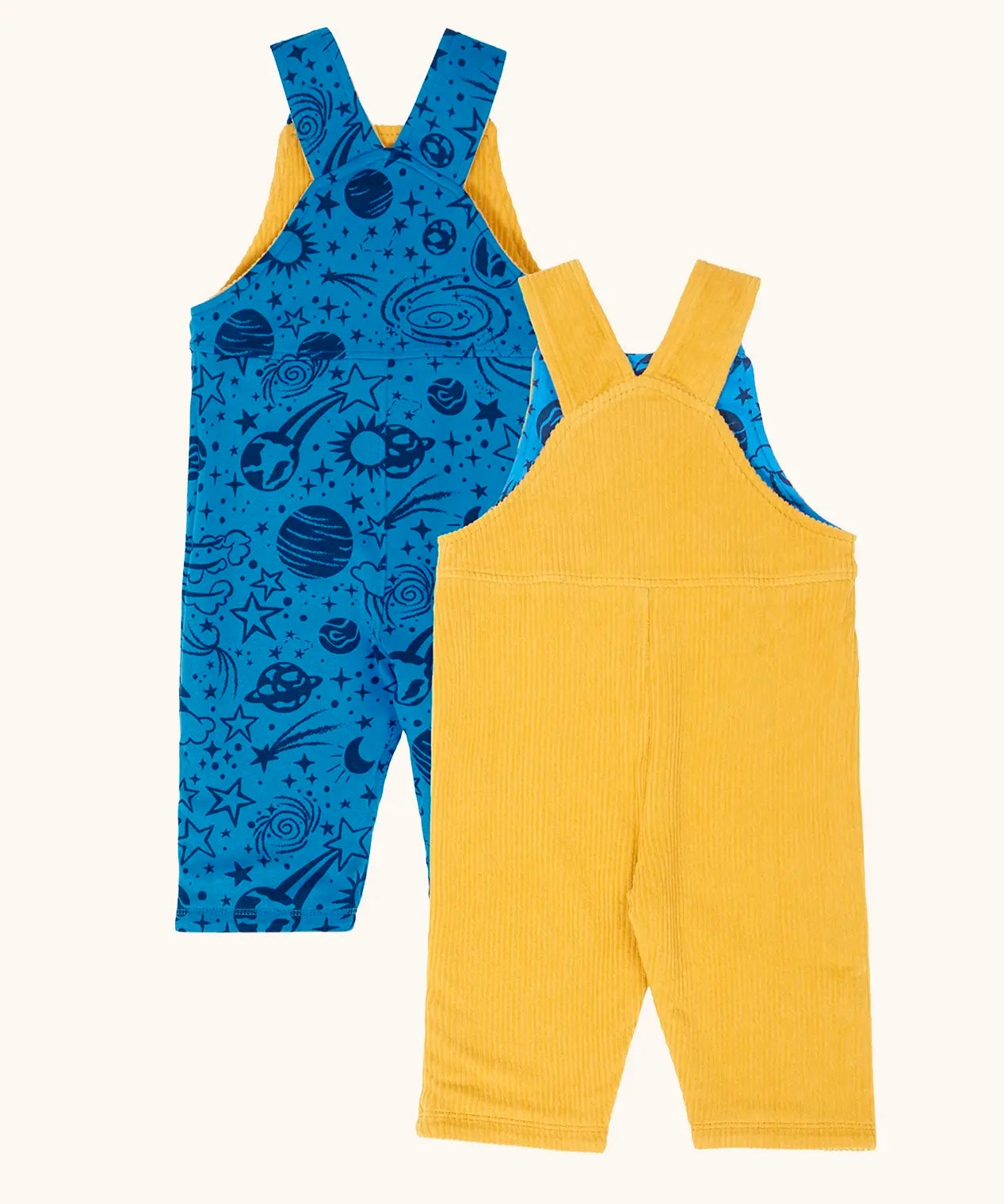 Back of the Frugi Gylly cord reversible dungaree in bumblebee yellow with star pocket design on one side and blue all over monochrome space print on the other.