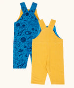 Back of the Frugi Gylly cord reversible dungaree in bumblebee yellow with star pocket design on one side and blue all over monochrome space print on the other.