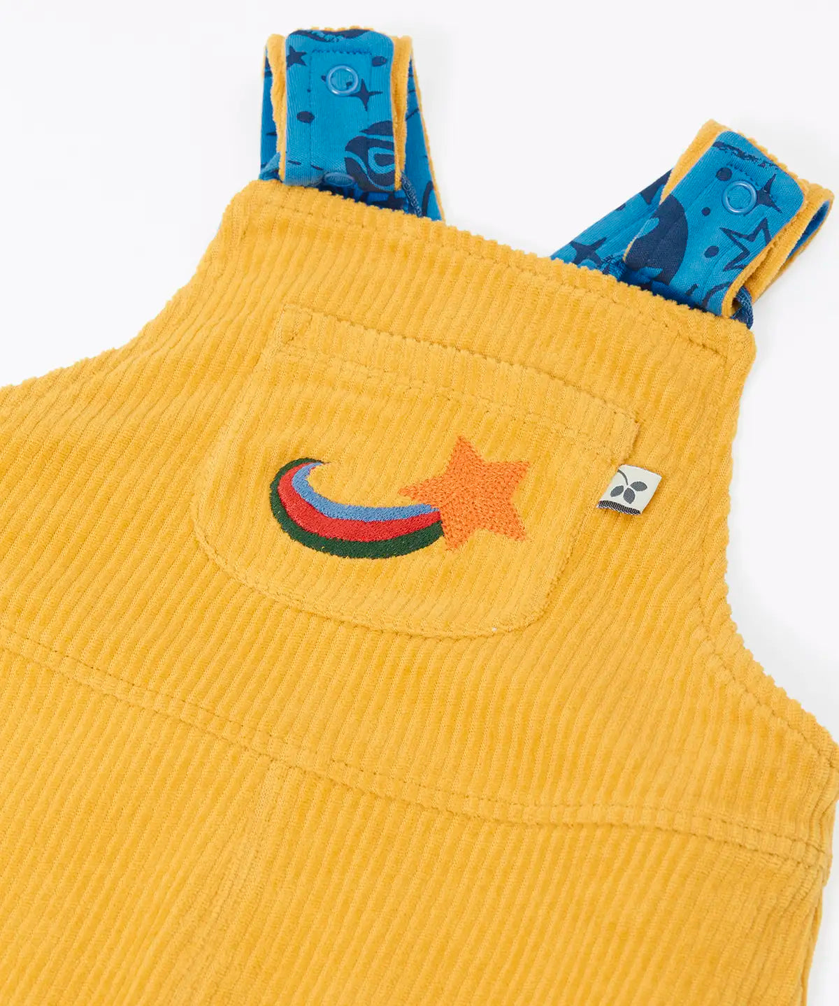 Close up of the embroidered star detail on the front chest pocket of the Frugi Gylly cord reversible dungaree in bumblebee yellow.