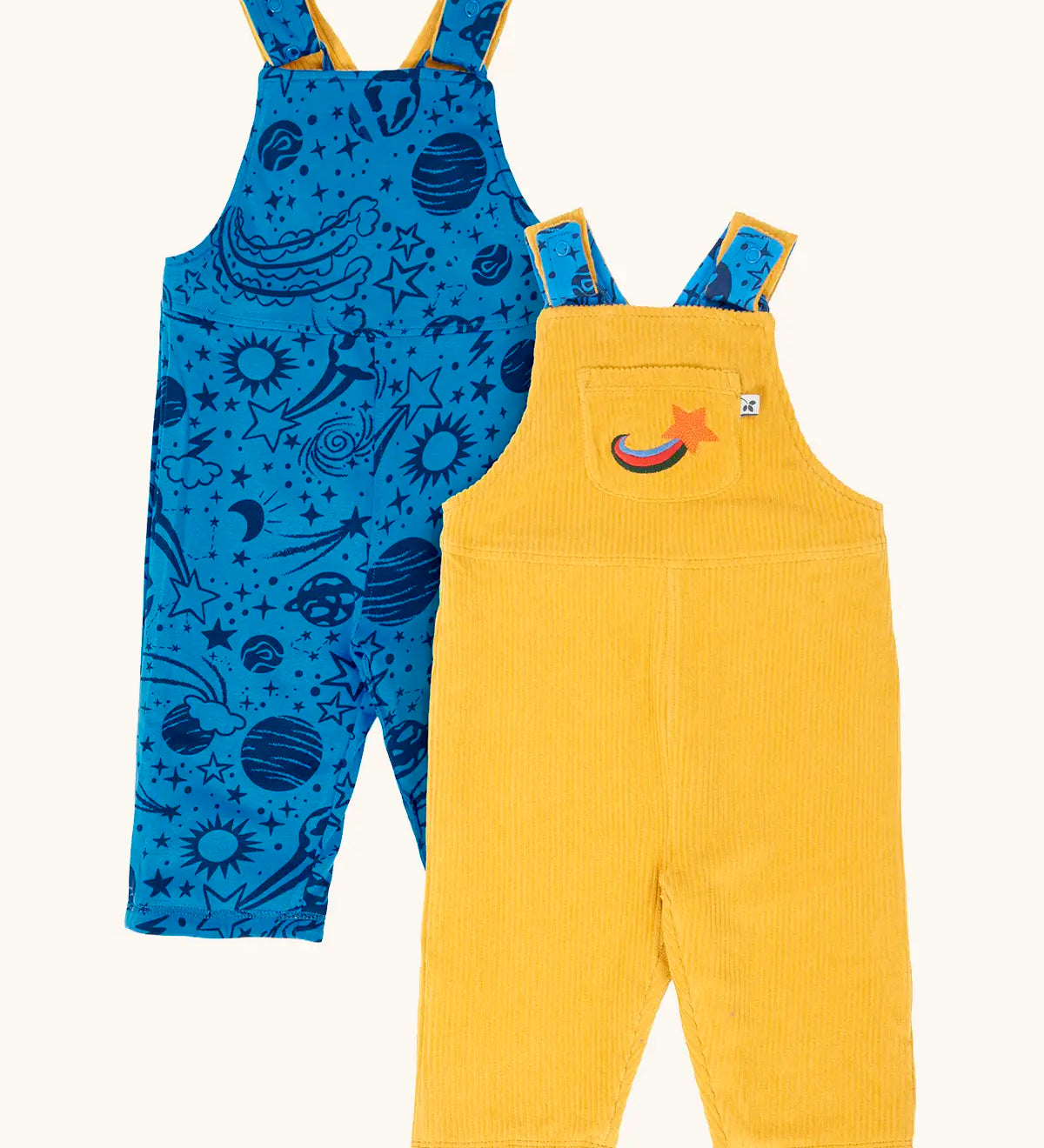 Frugi Gylly cord reversible dungaree in bumblebee yellow with star pocket design on one side and blue all over monochrome space print on the other.