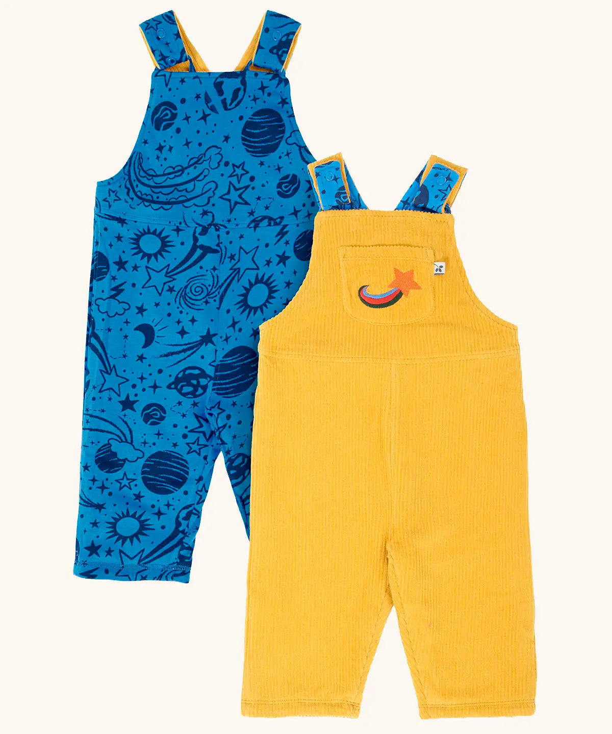 Frugi Gylly cord reversible dungaree in bumblebee yellow with star pocket design on one side and blue all over monochrome space print on the other.