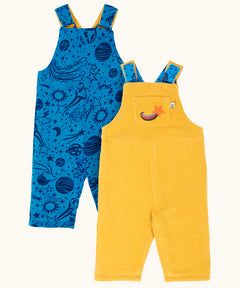 Frugi Gylly cord reversible dungaree in bumblebee yellow with star pocket design on one side and blue all over monochrome space print on the other.