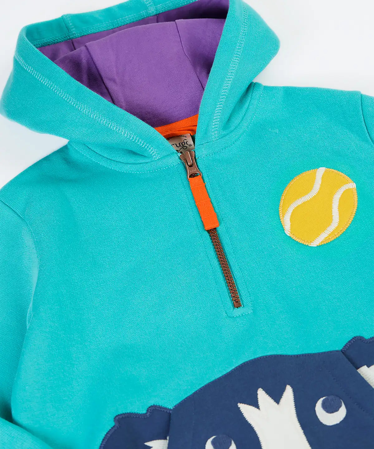 A close up of the zip up closure on the front of the Frugi Hadley hoodie op with dog applique on the front.