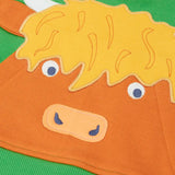 Close up of the Highland cow kangaroo pocket on the front of the Frugi Hadley half zip hoodie in palm green.