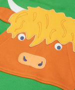 Close up of the Highland cow kangaroo pocket on the front of the Frugi Hadley half zip hoodie in palm green.