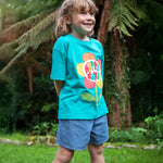 A child wearing the Frugi  Happy Days Mabe Relaxed T-Shirt with denim shorts 