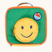 Front of the Frugi happy smiley face rectangular lunch bag. A green coloured front with orange binding around the edges and a circular shaped zipped pocket in the middle featuring the happy smiley face. 
