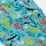 A close up of Frugi Eira Harems, featuring a Sea Life print which includes different sea animals and colourful seaweed and coral on a mint blue background.