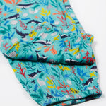 A close up of Frugi Eira Harems folded legs, featuring a Sea Life print which includes different sea animals and colourful seaweed and coral on a mint blue background.
